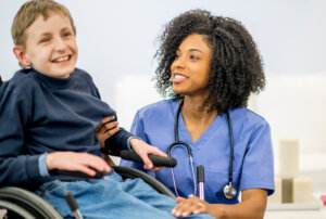 nurse with person supported in wheelchair
