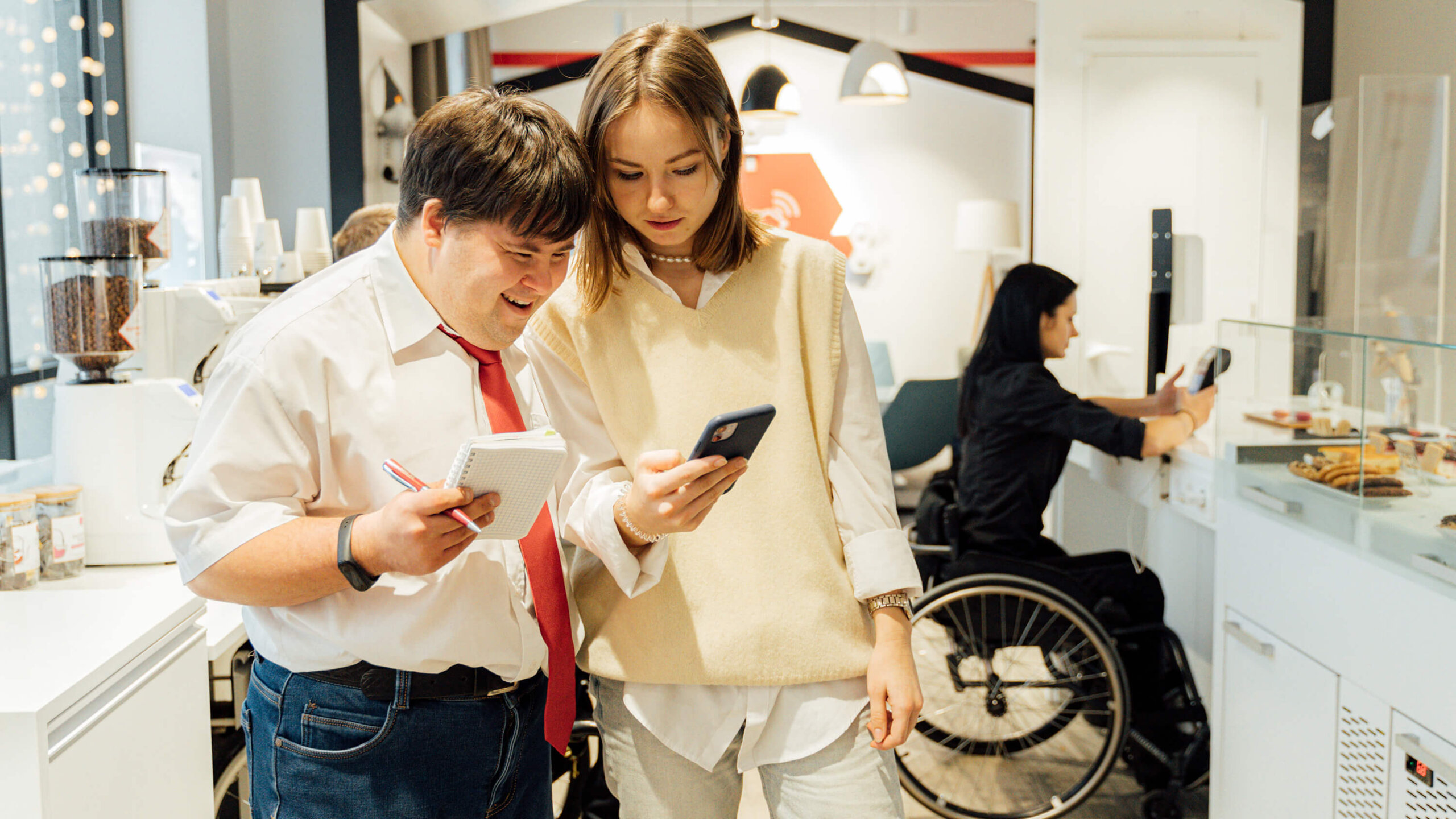Smiling man being helped by woman in Disability Program