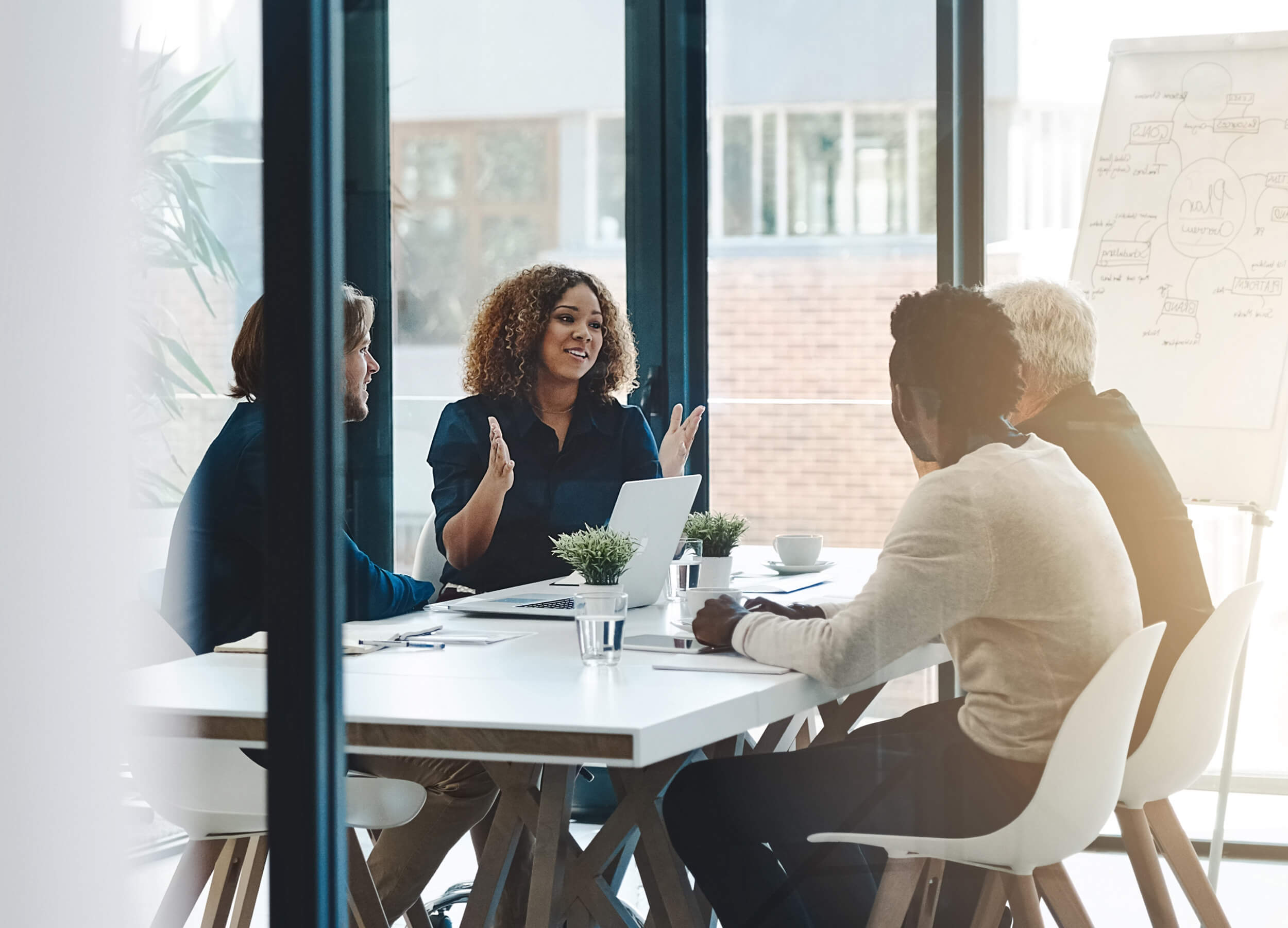 Diverse managers smiling during a strategy meeting